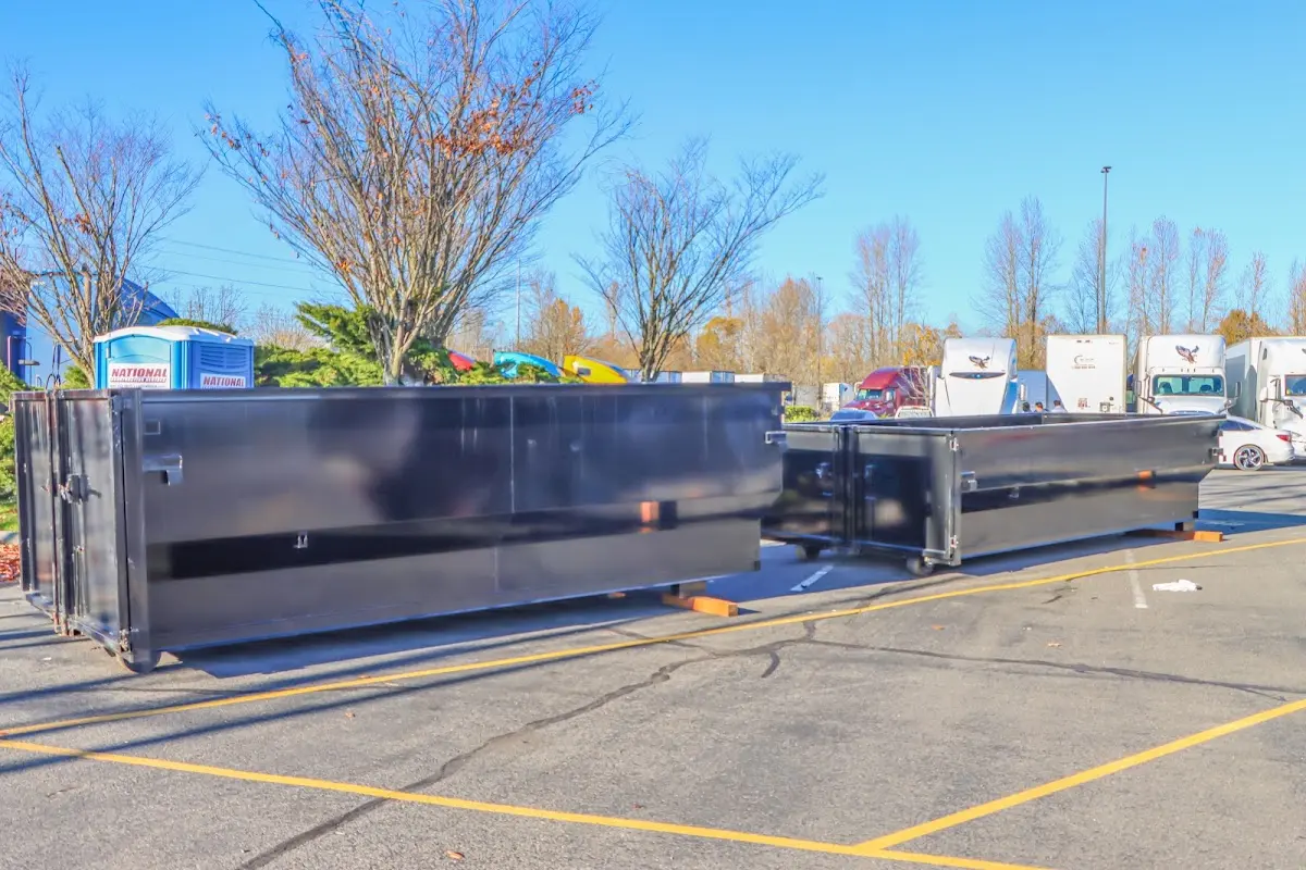 Professional dumpster rental service with roll-off container on residential driveway in Plain City